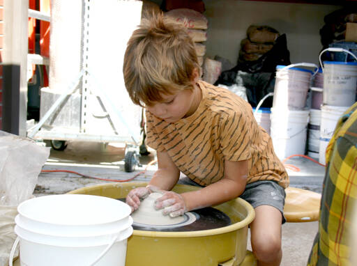 Photo by Paula Hunt/Olympic Peninsula News Group
Eliott Carey, 5, shapes a mound of clay on a potters wheel on the patio of Peninsula Colleges ceramics studio at its second Fall Spectacular in 2023. This years event is scheduled for Saturday, Sept. 7.