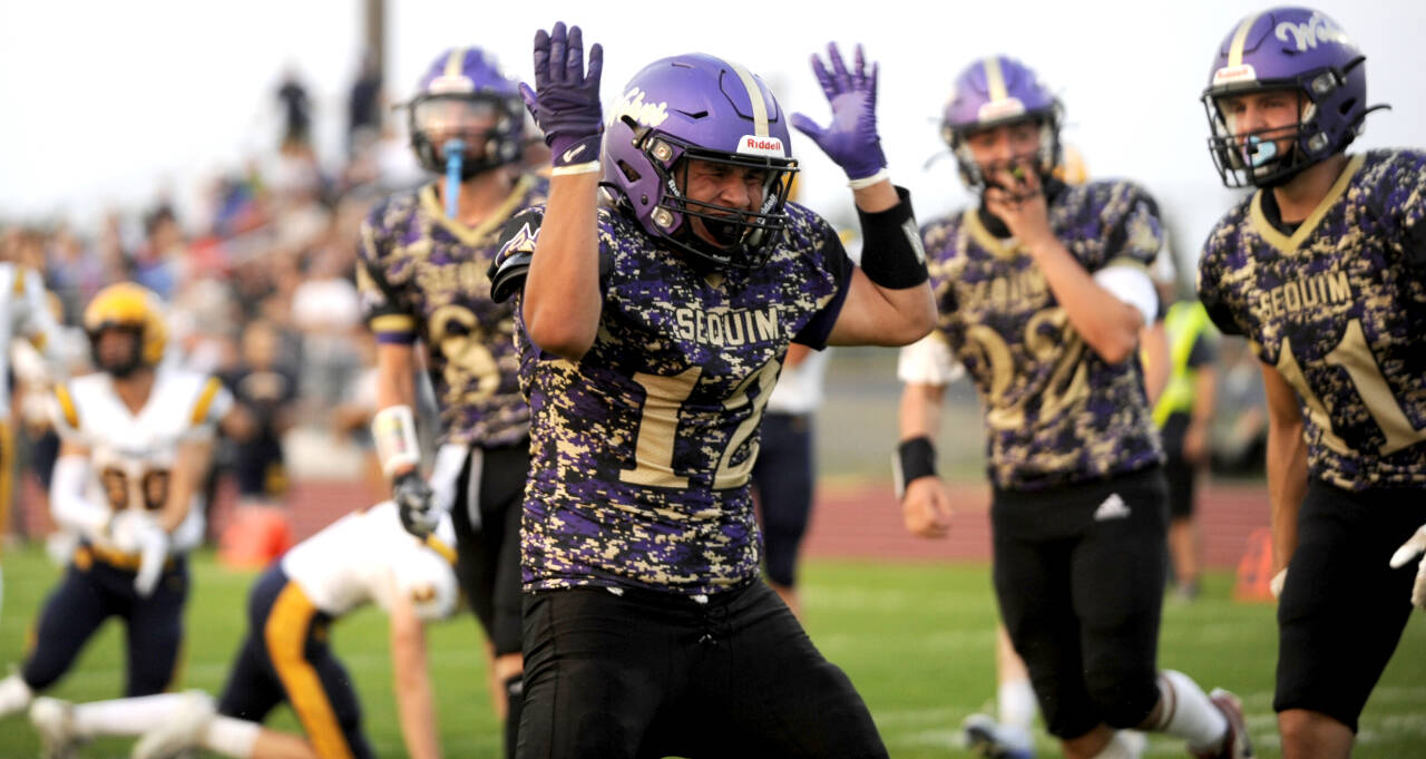 Sequim Gazette photo by Michael Dashiell / Sequim High running back Liam Wiker celebrates the first of two touchdowns in the Wolves season-opening 35-26 win over Forks on Sept. 6.