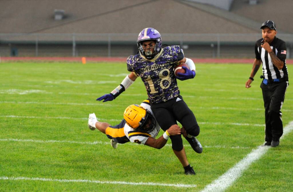 Sequim Gazette photo by Michael Dashiell / Sequims Malachi Hampton, a transfer from Olympic, breaks free of a tackle by Forks Bubba Hernandez for a big gain in the first half of Sequims 35-26 win over the 1A Spartans on Sept. 6.