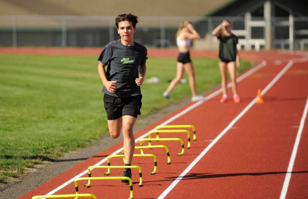 Sequim Gazette photo by Michael Dashiell / Sequims Jackson Hines gets a high-leg workout at the SHS track last week as he and cross country teammates prep for the 2024 season.