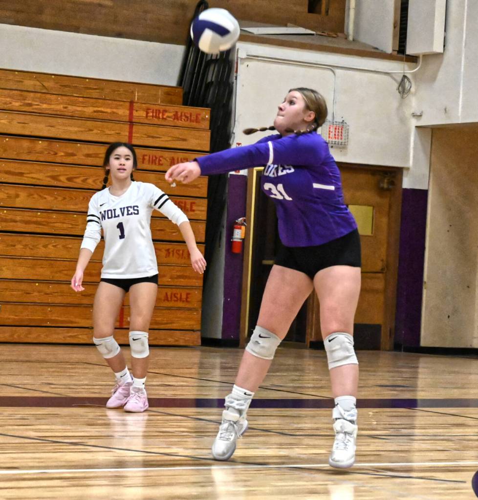 Sequim Gazette file photo by Michael Dashiell / As teammate Tiffany Lam, left, looks on, Sequims Ashton Reichner returns a Port Angeles serve as the Wolves take on  and beat  the Roughriders in an Olympic league match-up in October 2023. Both players are back on the 2024 team.