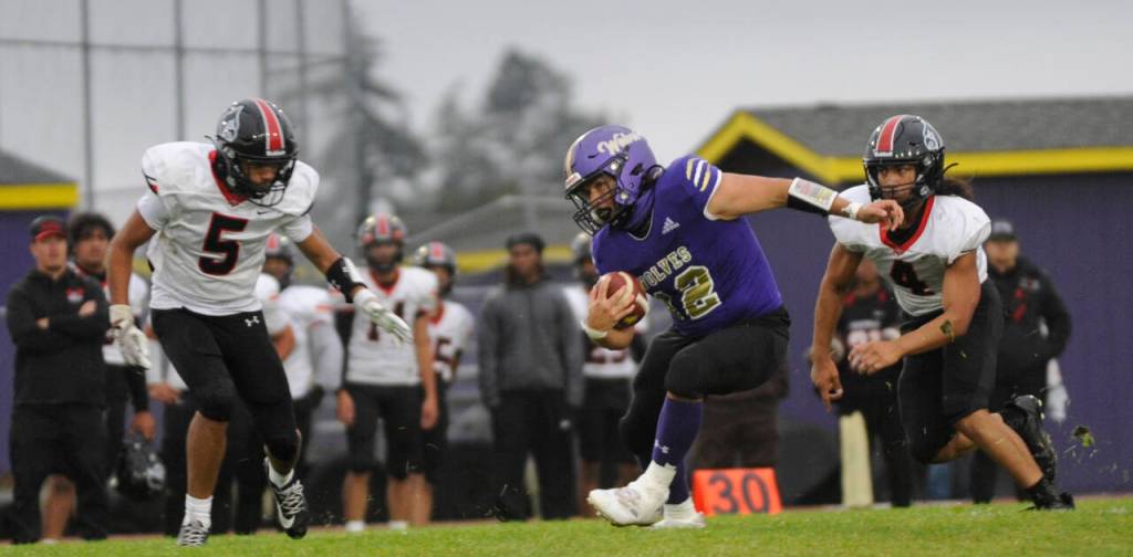 Sequim Gazette photo by Michael Dashiell / Sequims Liam Wiker looks to evade would-be Franklin Pierce tacklers the Wolves 36-14 loss to Franklin Pierce on Sept. 13.