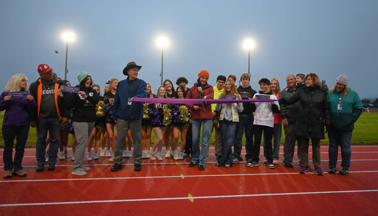 Sequim Gazette photo by Michael Dashiell / Sequim High sophomore Clare Turella does the honors, cutting a ceremonial ribbon to celebrate the Sequim School Districts newly-refurbished track on Sept. 13. Turella won a state 2A high jump title as a freshman in 2023.