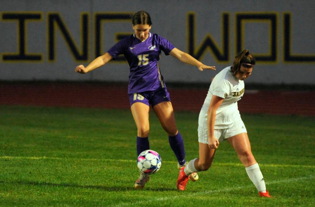 Sequim Gazette photo by Michael Dashiell / Sequim defender Harper Moore, left, snatches the ball from Bainbridges Izzi Pujolar in the first half of SHSs match-up with the Spartans on Sept. 19.