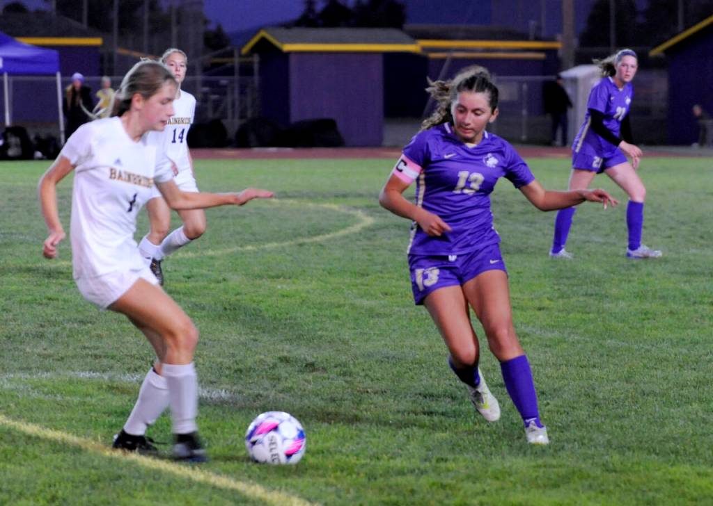 Sequims Amara Gonzalez, right and Bainbridges Vega Hendrickson vie for possession in the first half of a Sept. 19 Olympic League match-up in Sequim.