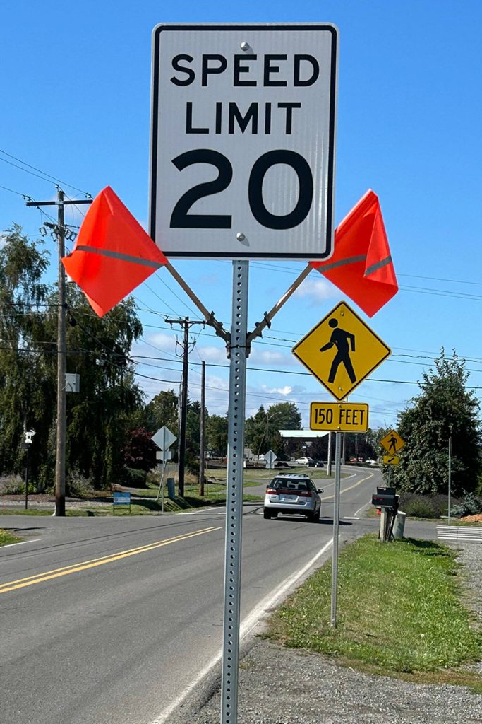 Sequim Gazette photo by Matthew Nash/ City staff put up flags to help bring awareness to a 20 mph zone on West Sequim Bay Road, and theyve ordered more signs, painted no passing lanes, and increased police patrols.
