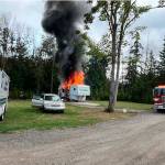 Photo courtesy Chris Turner, Clallam County Fire District 3/ Neighbors attempted to extinguish a fire inside an RV on Sept. 13 after an explosion forced its owner outside. Nearby residents also tended to the owner and moved his vehicle away from the fire as they awaited firefighters.