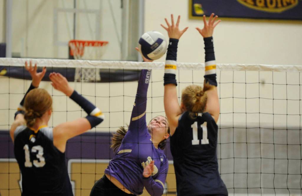 Sequim Gazette photo by Michael Dashiell / Sequims Brianna Palenik, center, looks to hit past Bainbridge blockers Carmen MacCulloch (13) and Rollins Anderson in an Olympic League match in Sequim on Sept. 19.
