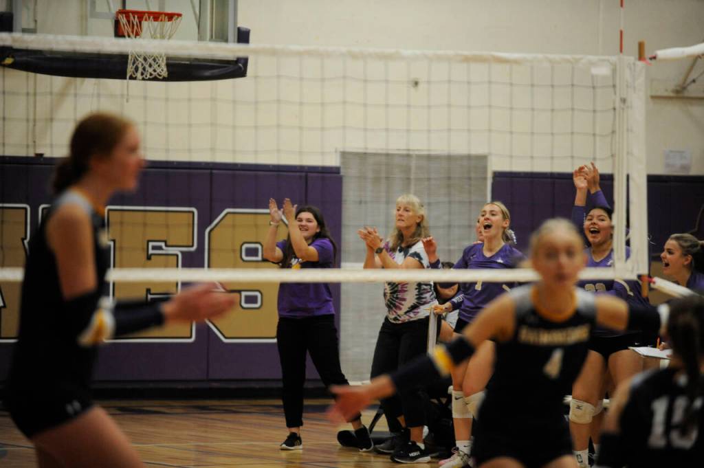 Sequim Gazette photo by Michael Dashiell / Sequim coaches celebrate a key point in the third set of a league match against Bainbridge on Sept. 19.