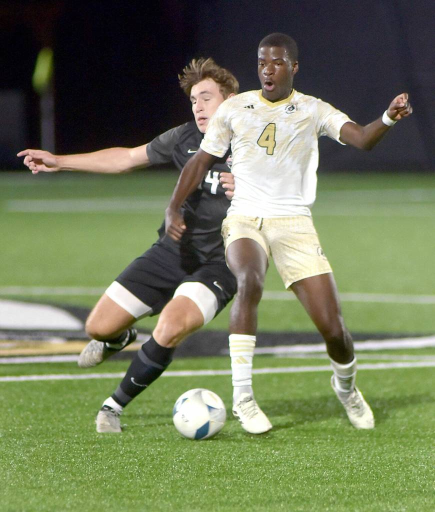 Photo by Keith Thorpe/Olympic Peninsula News Group / Peninsulas Jeremie Kuelo, front, defends the ball from Everetts Caleb Hirata during a Sept. 18 match at Wally Sigmar Field.