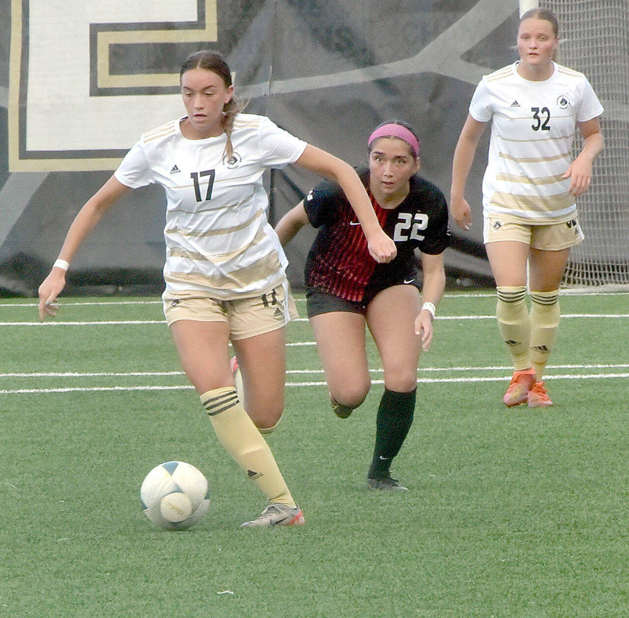Photo by Keith Thorpe/Olympic Peninsula News Group / Peninsulas Emma Crystal, left, drives down the pitch pursued by Everetts Cassandra Sotelo as Crystals teammate, Gemma Rowland, keeps watch on Sept. 18 at Wally Sigmar Field.