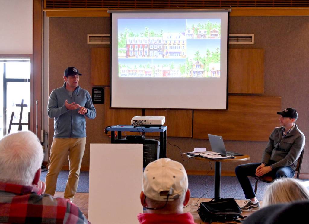 Sequim Gazette file photo by Michael Dashiell / Seabrook CEO Casey Roloff and Sam Nielson, Seabrooks vice president of engineering and entitlements, talk with community members about a proposed development adjacent to Sequim Bay at the John Wayne Marina on April 23.