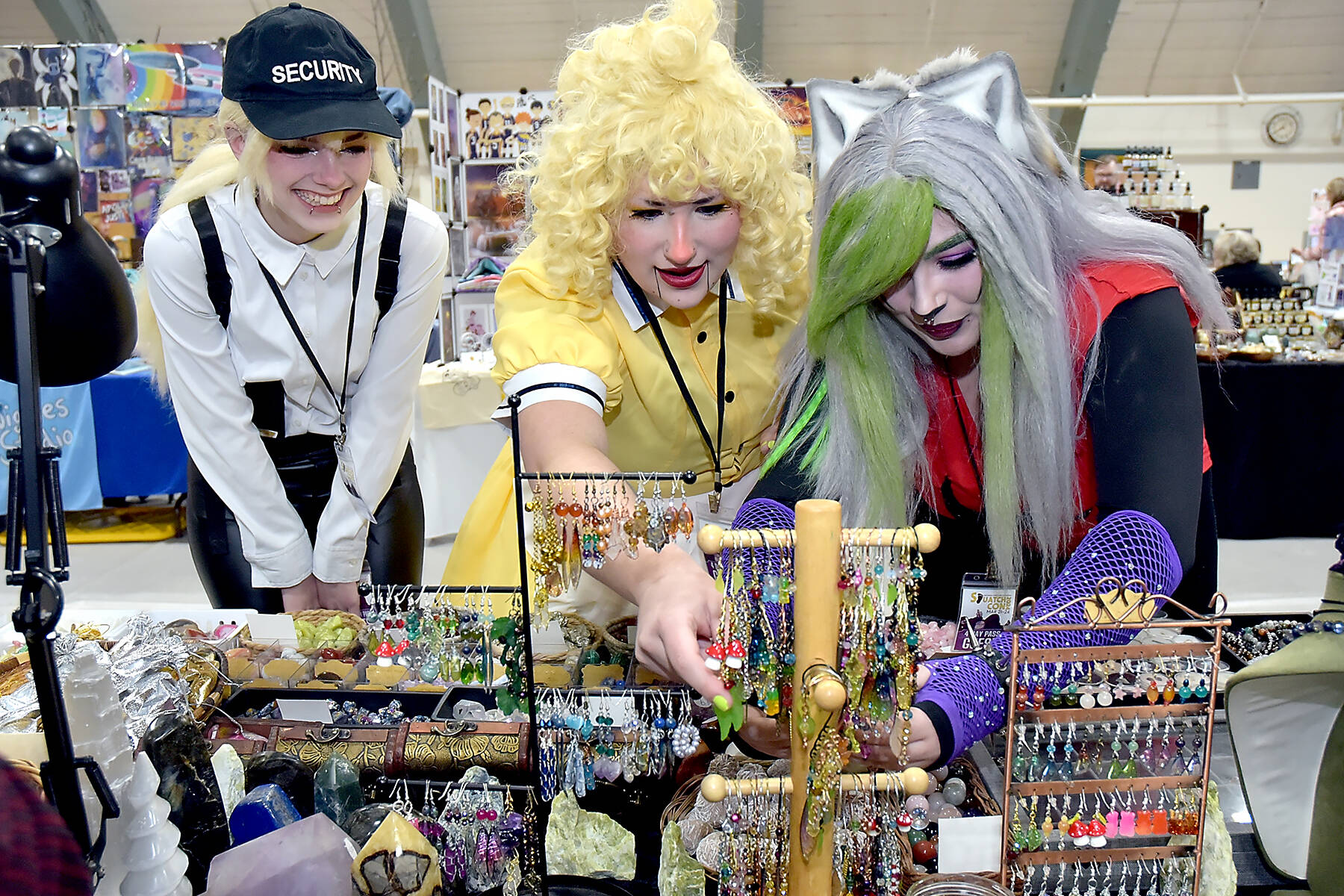 File photo by Keith Thorpe/Olympic Peninsula News Group
2023 Squatchcon convention attendees, from left, Kiera Woodward, Madison Peterson and Juliette Burnette, all of Port Angeles, examine displays of jewelry, earrings and crystals at a display table operated by Dragon Den Studios of Sequim at the Vern Burton Community Center in Port Angeles. The four-day festival, dedicated to gaming, culture and cosplay, invites artists and other vendors to apply for the next years Squatchcon, scheduled for April 10-13, 2025.