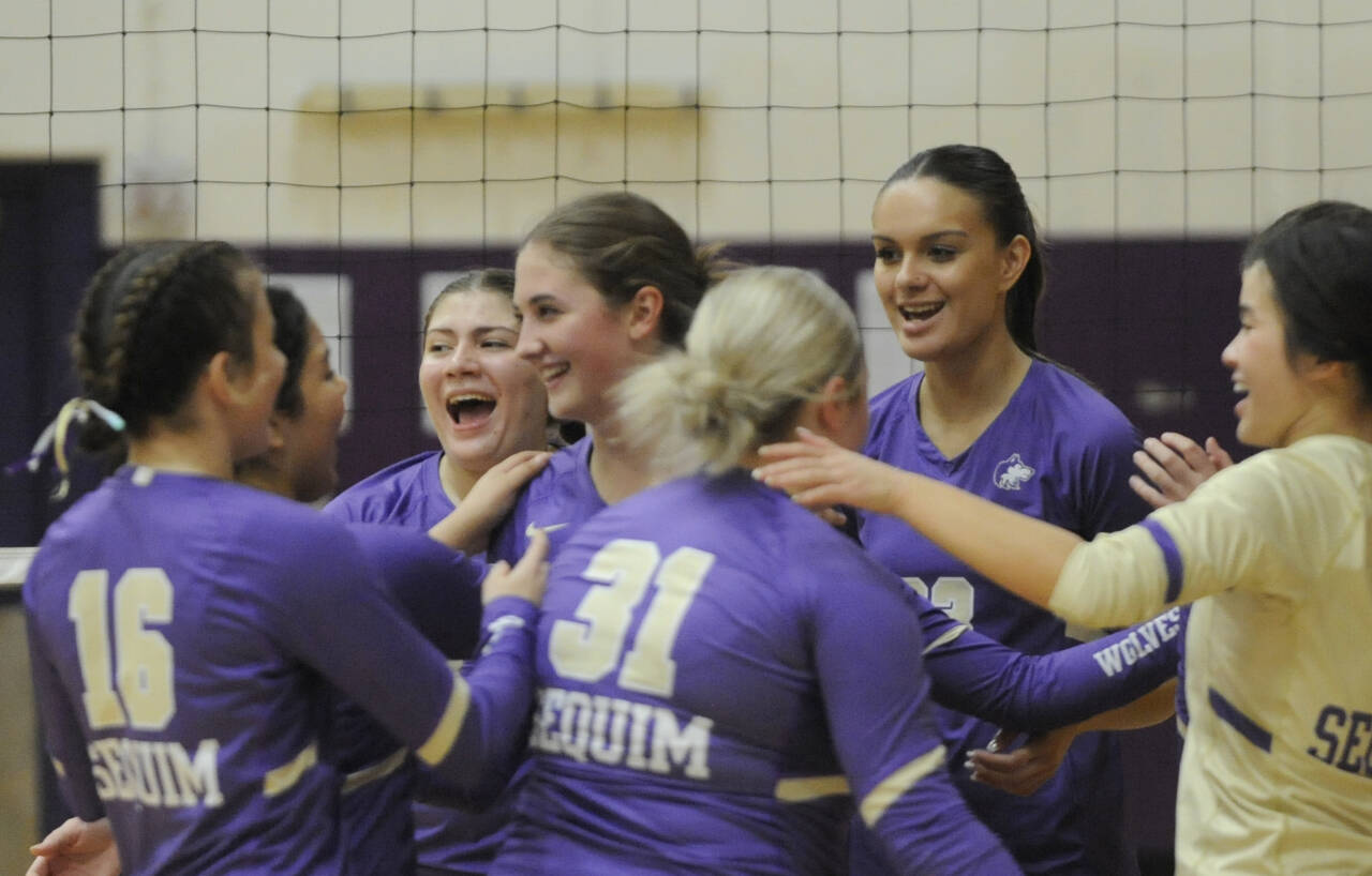 Sequim Gazette photo by Michael Dashiell / Sequim Highs volleyball squad celebrates a three-set win over Port Angeles on Sept. 26.