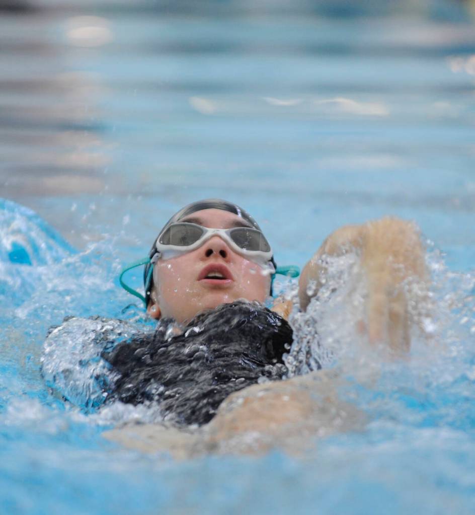 Sequim Gazette photo by Michael Dashiell / Sequims Audrey Cabbage competes in the 100 backstroke against Port Angeles in a Sept. 25 Olympic League meet in Sequim.