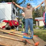 Sequim Gazette photo by Matthew Nash/ Jim Hollatz with the Back Country Horsemen talks to children at the Dungeness River Festival about the tools their volunteers use to clear trails at all angles.
