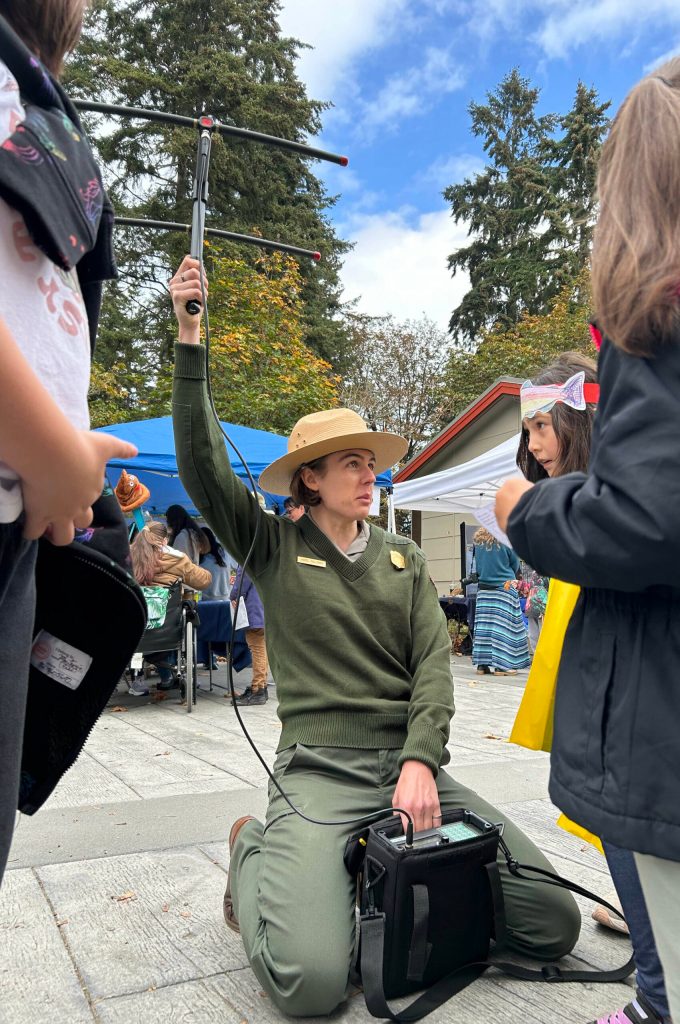 Sequim Gazette photo by Matthew Nash/ Park Ranger Hazel Galloway, a science communications specialist in the Olympic National Forest, shows students how she uses an antennae to track bats, including one toy bat she hid nearby.