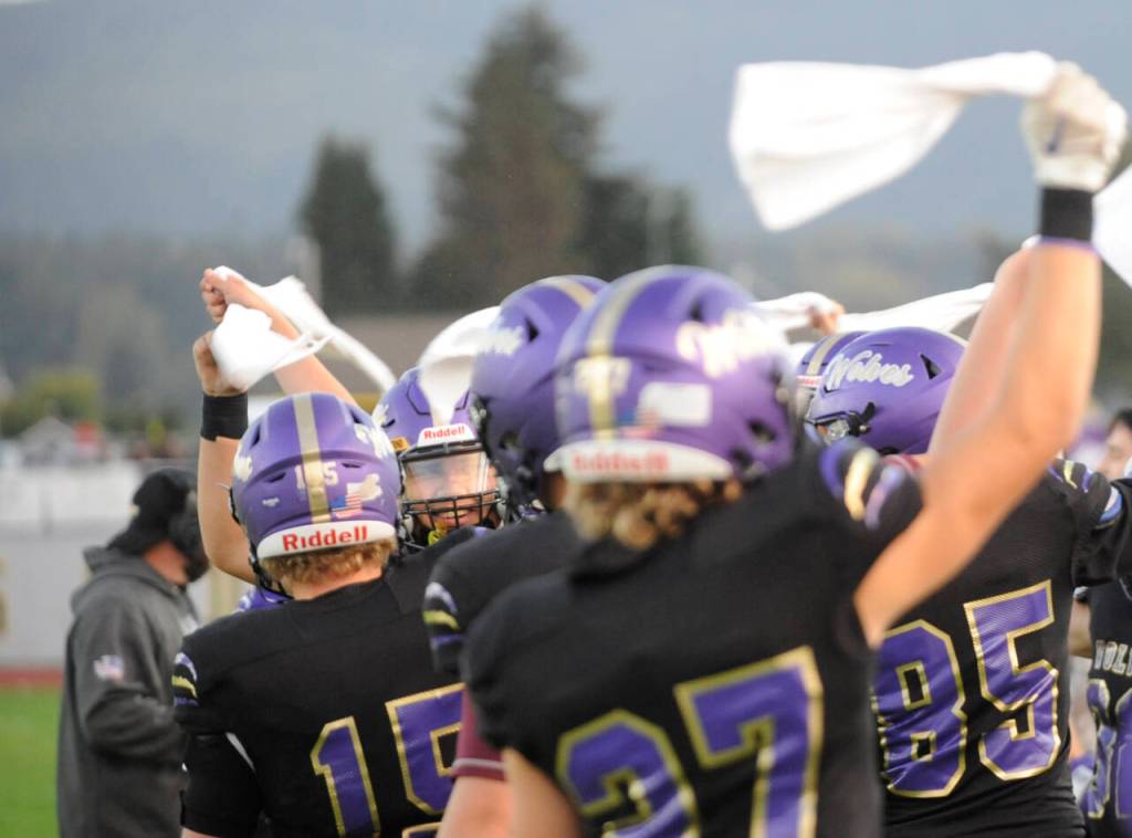 Sequim Gazette photo by Michael Dashiell / Sequim players get the crowd going with their traditional Homecoming towel play  one that turned out to be a halfback pass  to open the Wolves match-up with Port Angles on Sept. 27.
