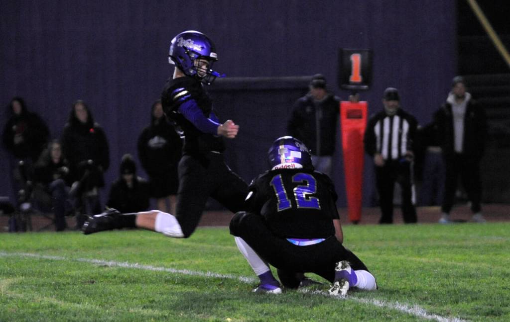Sequim Gazette photo by Michael Dashiell / Sequims Joseph Henninger, left, gets a good hold from Liam Wiker to connect for a point-after attempt in SHSs 27-7 win over Port Angeles on Sept. 27. Henninger made three of four extra points.
