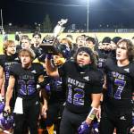 The Sequim Wolves celebrate winning the Rainshadow Rumble trophy in Sequim on Friday night. Sequim beat Port Angeles 27-7. (Michael Dashiell/Olympic Peninsula News Group)