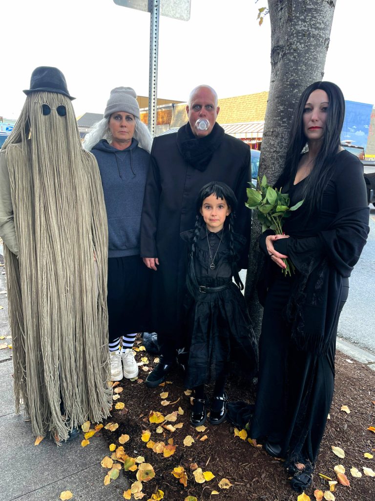 Sequim Gazette file photo by Matthew Nash
Last Halloween, the Addams Family, from left, Cousin Itt (Greg Good), Grandmama (Erica Harris), Uncle Fester (Erik Good), Morticia (Nikki Sather) and Wednesday (Stella Good) trick-or-treat during the Sequim Merchants annual event. It returns 3-5 p.m. Thursday, Oct. 31 in and near downtown Sequim.