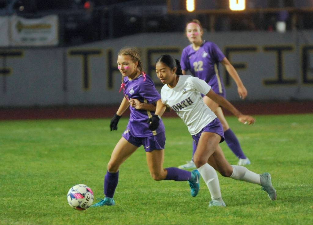Sequim Gazette photo by Michael Dashiell / Sequims Kiley Winter, left, battles a North Kitsap player for possession in SHSs 1-0 loss to No. 7-ranked NK at home on Oct. 1. SHSs Hailey Wagner (background) looks on.