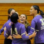 Sequim Gazette photo by Michael Dashiell / Sequim teammates celebrate a match-clinching point from Kassi Montero (14) as the Wolves sweep Kingston at home on Oct. 8.