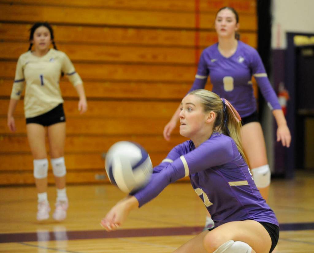 Sequim Gazette photo by Michael Dashiell / Sequims Sydney Clark digs a ball as teammates Tiffany Lam, left, and Rose Gibson look on in the Wolves 3-0 sweep of Kingston on Oct. 8.
