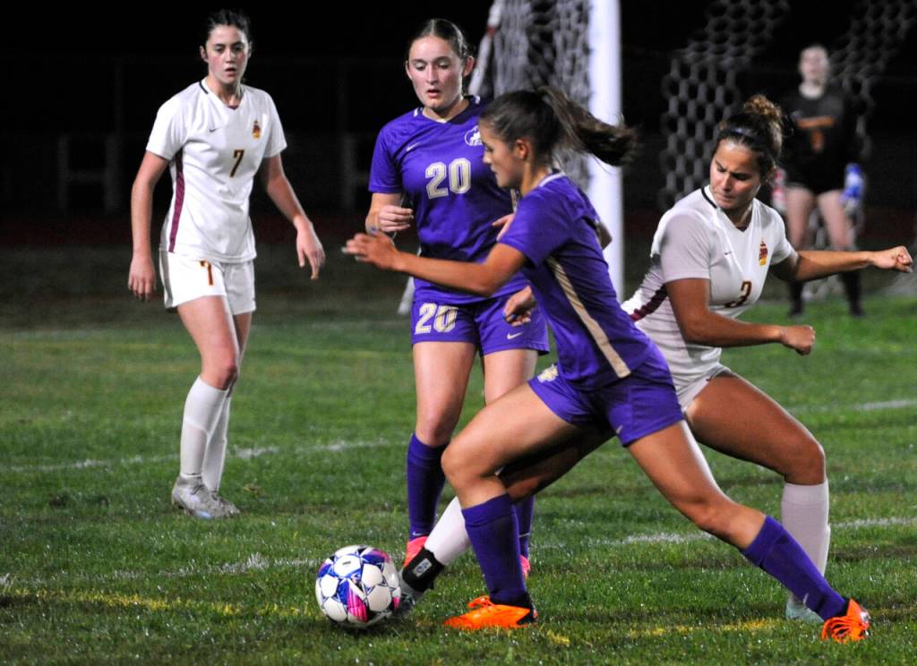 Sequim Gazette photo by Michael Dashiell / As teammate Sasha Yada (20) looks on, Sequims Raimey Brewer looks for space to put up a shot on goal in the Wolves Oct. 8 Olympic League game against Kingston.