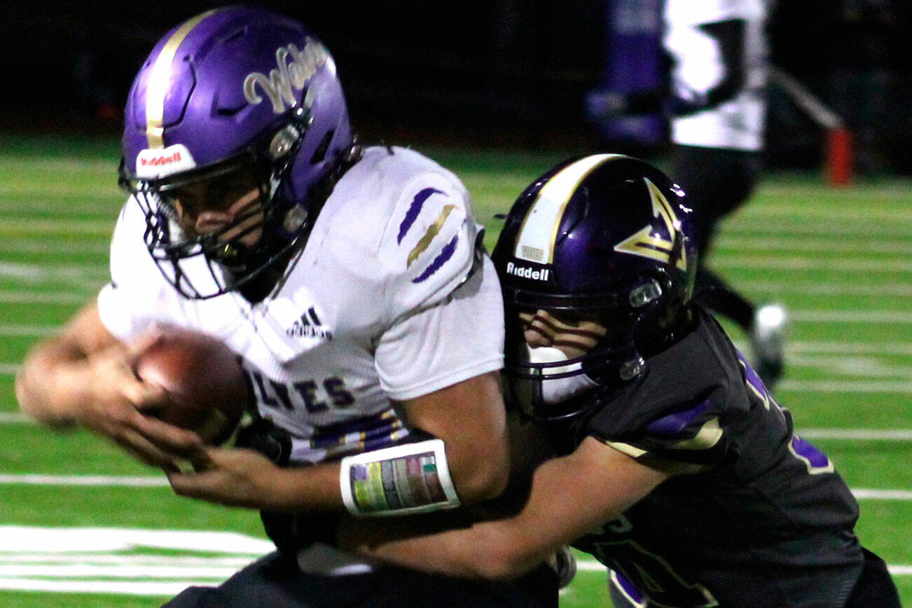 Photo by Elisha Meyer/Kitsap News Group Sequims Liam Wiker is tackled by North Kitsaps Townsyn Walsh in the first half of the Wolves 30-7 Olympic League loss in Poulsbo on Oct. 10.