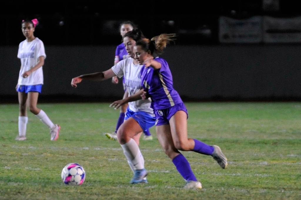 Sequims Ruby Moxley-Horgan, right, jockeys for position during the Wolves 5-0 win over Olympic at home on Thursday.