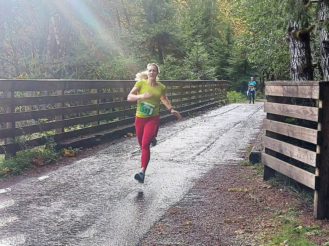 Photo by Pierre LaBossiere/ Olympic Peninsula News Group/ Sara Kuethe of Bainbridge Island won the womens 10K at the inaugural Spruce Railroad Run at Lake Crescent on Saturday, Oct. 19.