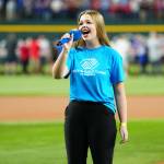 Photo by Mary DeCicco/MLB Photos via Getty Images/ Boys & Girls Clubs Youth Performer Pearle Peterson of Sequim sings the national anthem prior to Game 2 of the 2023 World Series between the Arizona Diamondbacks and the Texas Rangers on Oct. 28 in Arlington, Texas. She sings again at the World Series in Los Angeles on Oct. 26, 2024.