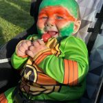 Sequim Gazette photos by Matthew Nash
As Michelangelo the Teenage Mutant Ninja Turtle, baby Ivar enjoys a lollipop with his parents Jessica and Dustin Baker at the Sequim Prairie Granges Fall Festival and Trunk-or-Treat.