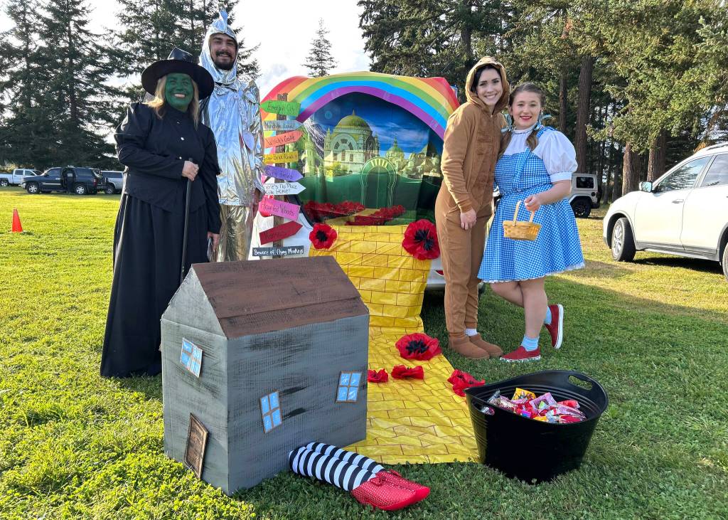 For the Sequim Prairie Granges Fall Festival and Trunk-or-Treat on Oct. 26, Tonya Opdyke as the Wicked Witch of the West, Michael Schleve as the Tin Man, Olivia Necco as the Cowardly Lion and Raelynn Opdyke as Dorothy recreate scenes from The Wizard of Oz.