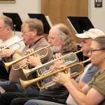 Photo by Mark Wick/Sequim City Band / From left, Jim Bradbury, Terry Fogerson, Michael Hornbaum, Doug Brundage and Nancy McPherson, the trumpet section of the Sequim City Band, play at a rehearsal.