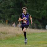 Sequim Gazette photo by Michael Dashiell / Sequim High freshman Johnathan Tipton finishes the Olympic League championships course last week.