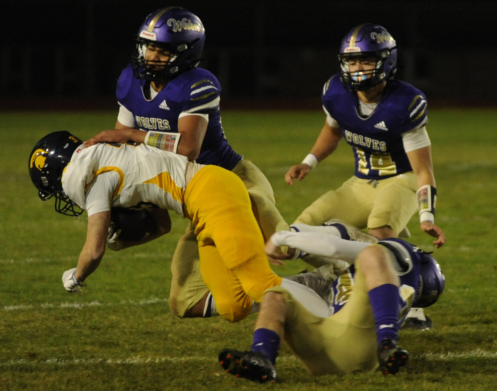 Sequim Gazette photos by Michael Dashiell
Sequims Solomon Sheppard, left, and James Mason, foreground, corral Bainbridges Rowan Meek as SHS teammate Zeke Schmadeke looks on in the first half of the Wolves Oct. 25 home game against Bainbridge.