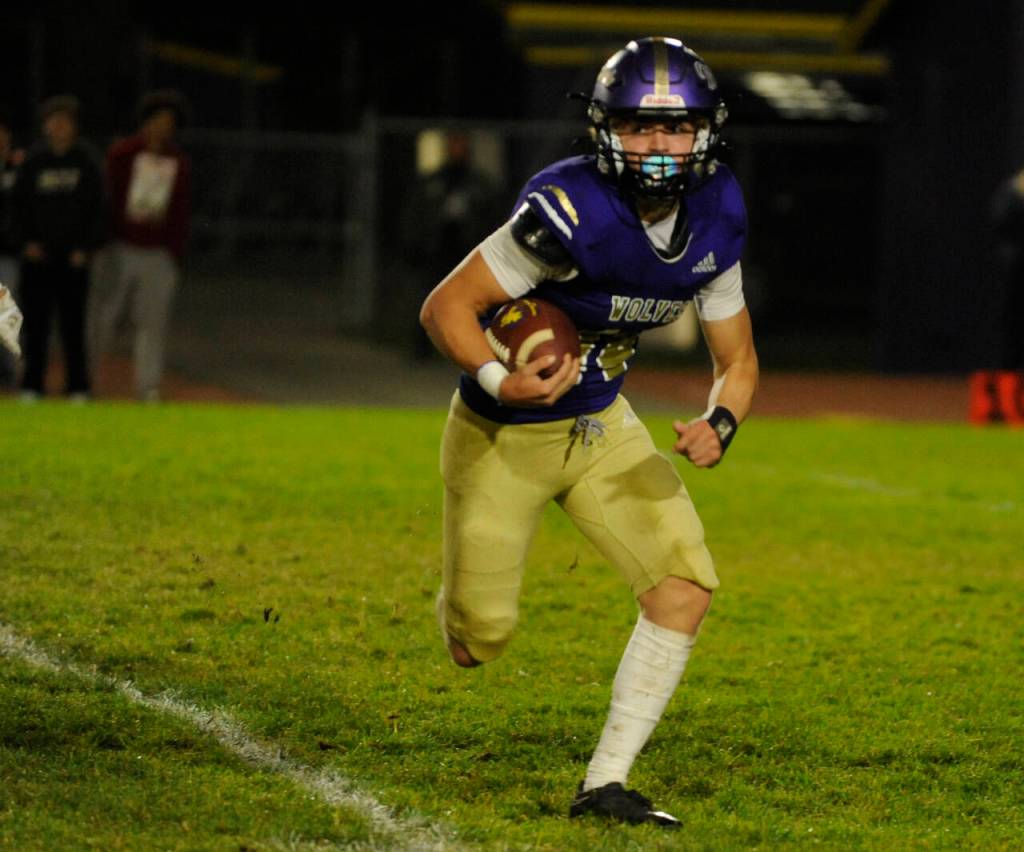 Sequim Gazette photo by Michael Dashiell / Sequim quarterback Zeke Schmadeke looks for running room in the first half of an Olympic League match-up with Bainbridge on Oct. 25. Schmadeke had the Wolves lone first half score, a 5-yard touchdown scamper.