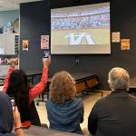 Sequim Gazette photo by Matthew Nash
Mary Budke, executive director of the Boys Girls Clubs of the Olympic Peninsula, and fellow supporters cheer for Pearle Peterson on Oct. 26 from inside the Sequim club as Peterson sings the national anthem at game two of the World Series.