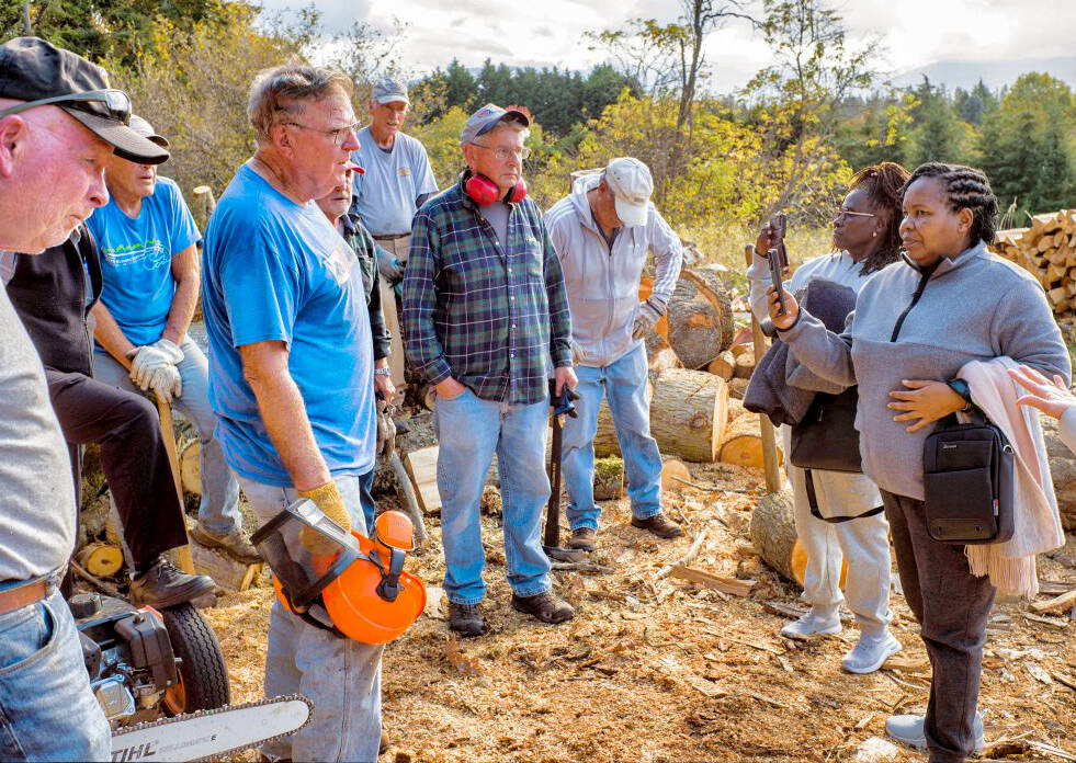 Photo by Bob Lampert / Agnes Kioko (far right) and Regina Mbaluku of Kenya meet with Sequim volunteers who cut and sell wood as a fundraiser for the Path From Poverty program.
