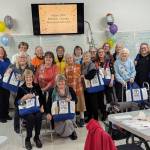 Photos by Christine Brehan
Olympic Peninsula Doll Club members pose with their new OPDC 50th birthday tote bags.