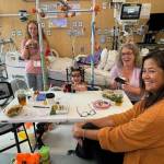 Photo by Sequim Picklers pickleball club / Members of the Sequim Picklers pickleball club Care Team help the Bo family as 5-year-old daughter Ellie gets treatment at Seattle Childrens Hospital. Pictured, at left, is Ellies mom Shauna.