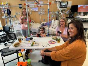 Photo by Sequim Picklers pickleball club / Members of the Sequim Picklers pickleball club Care Team help the Bo family as 5-year-old daughter Ellie gets treatment at Seattle Childrens Hospital. Pictured, at left, is Ellies mom Shauna.