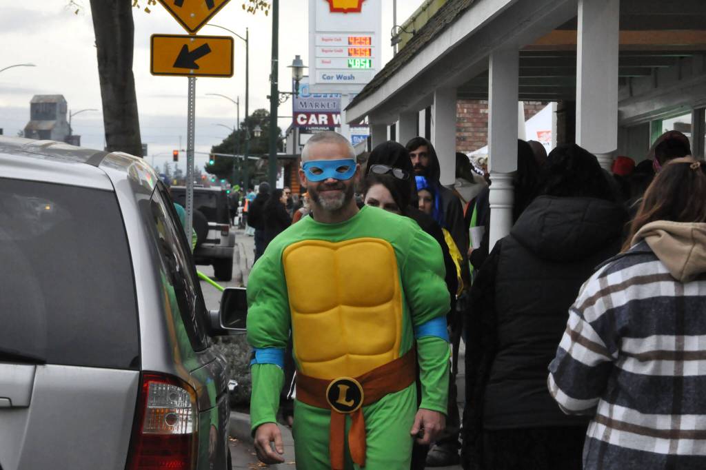 Kevin Pedrey walks in downtown Sequim on Halloween as Leonardo the Teenage Mutant Ninja Turtle. Pedrey said the character was a childhood favorite and he bought it eight years ago when his son was 1, and he wanted to wear it again.