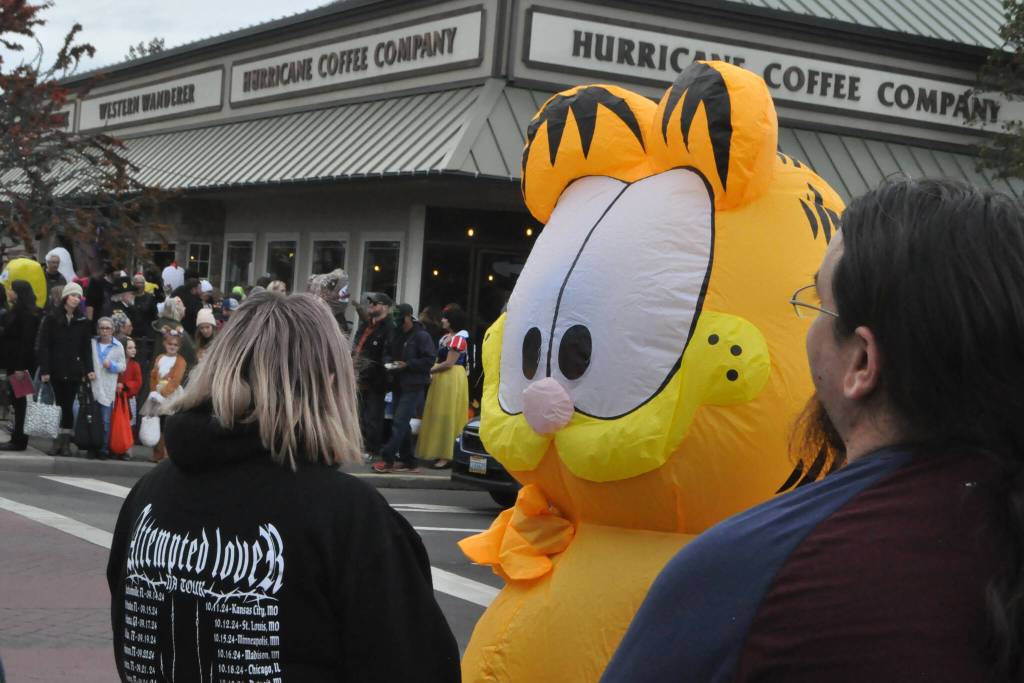 Sequim Gazette photo by Matthew Nash/ Garfield awaits the stoplight change at Centennial Place on Halloween in downtown Sequim.