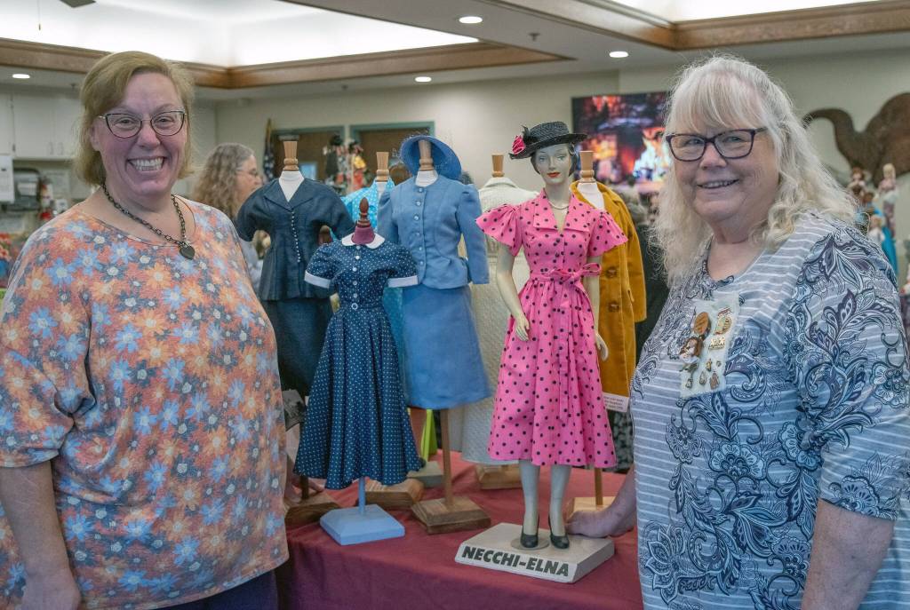 Christine Brehan, left, current Olympic Peninsula Doll Club president, and Sandy Brehan, cofounder of the group, share some of Sandys collection of miniature mannequins dressed in clothes that she made from original 1930s-1950s patterns. The blue skirt suit on the left was made by another member. The Brehans shared some of their collections with visitors and residents of Sherwood Assisted Living on Saturday.