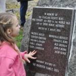 Sequim Gazette photos by Matthew Nash
Clara (Rhodefer) Muma, 5, looks at a memorial honoring her great-great-great uncle Clyde Rhodefer of Sequim in front of Carlsborg Family Church on Nov. 9. The plaque was replaced and added the names of the men from Clallam County who died in World War I.