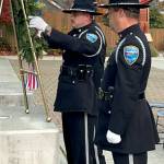 Sequim Gazette photo by Matthew Nash/ Sequim Police officers, from left, Taran Johnson, Mark Poole and Paul Dailidenas place a wreath to honor veterans on Nov. 8 at the City of Sequims flag poles during a ceremony.