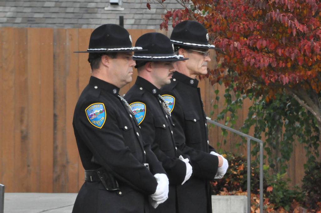 Sequim Gazette photo by Matthew Nash/ Sequim Police officers, from left, Paul Dailidenas, Taran Johnson and Mark Poole stand at attention during a ceremony to honor veterans on Nov. 8.